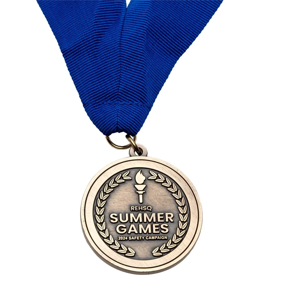Antiqued gold event medal on a blue neck ribbon with a torch and laurel wreath design