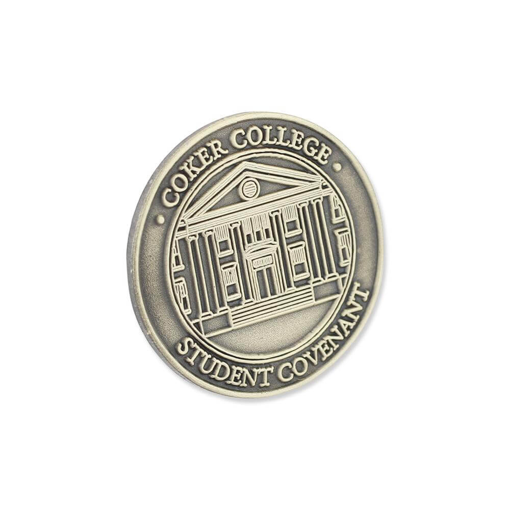 Die struck pin with recessed and raised artwork