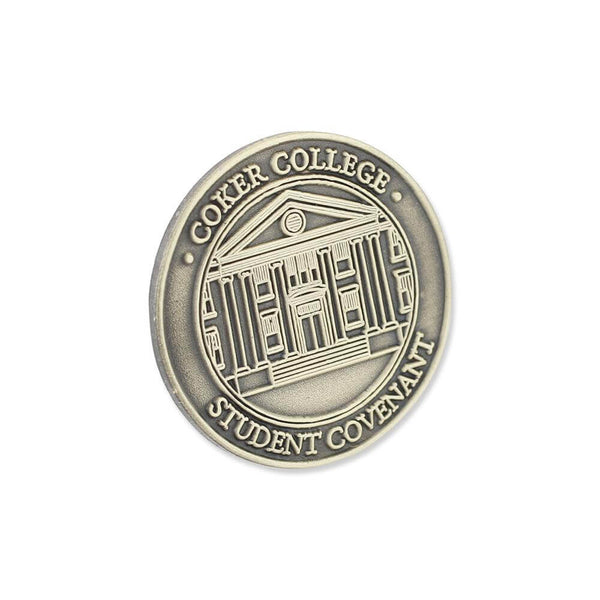 Die struck pin with recessed and raised artwork