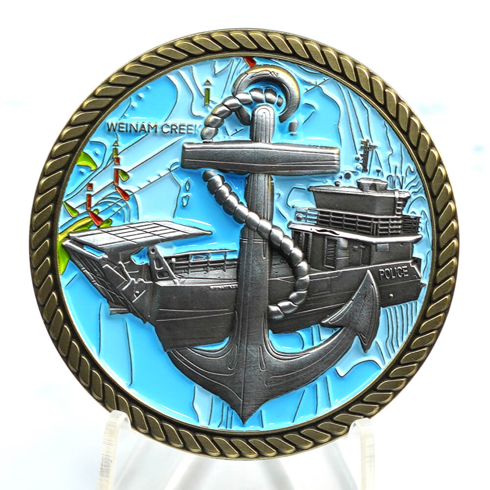 Custom blue naval anchor challenge coin with raised detail and rope edge