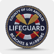 Round custom embroidered lifeguard patch with rope-style border and lettering