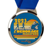 Custom marathon medal with a colour enamel sunrise and mountain landscape set in a polished silver rim