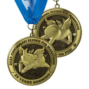 Polished gold 3D cast custom marathon medals with a sculpted winged pig and an anniversary rim