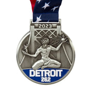 Antique silver 3D cast custom marathon medal with a torch-bearing figure, a bridge and the 26.2 distance in blue enamel