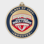 Custom hall of fame induction medal in antique gold with navy and red enamel school crest