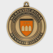 Custom academic scholar medal in antique gold with an orange enamel shield and concentric borders